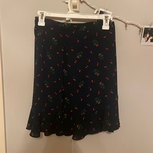Navy blue mini skirt with red cherries